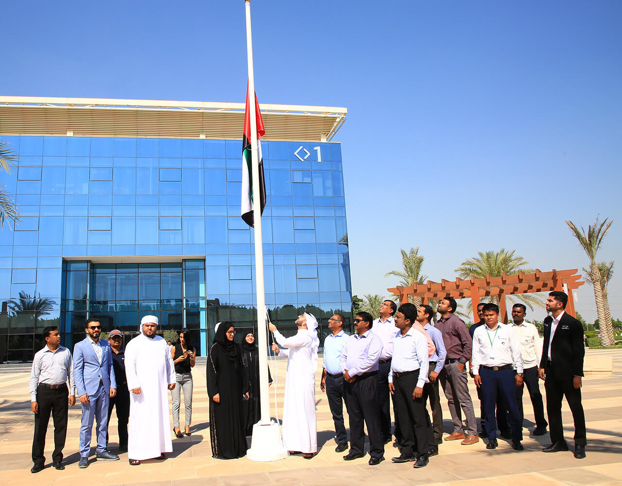 People hoisting the UAE National Flag at the Flag Day celebrations in Dubai Industrial City