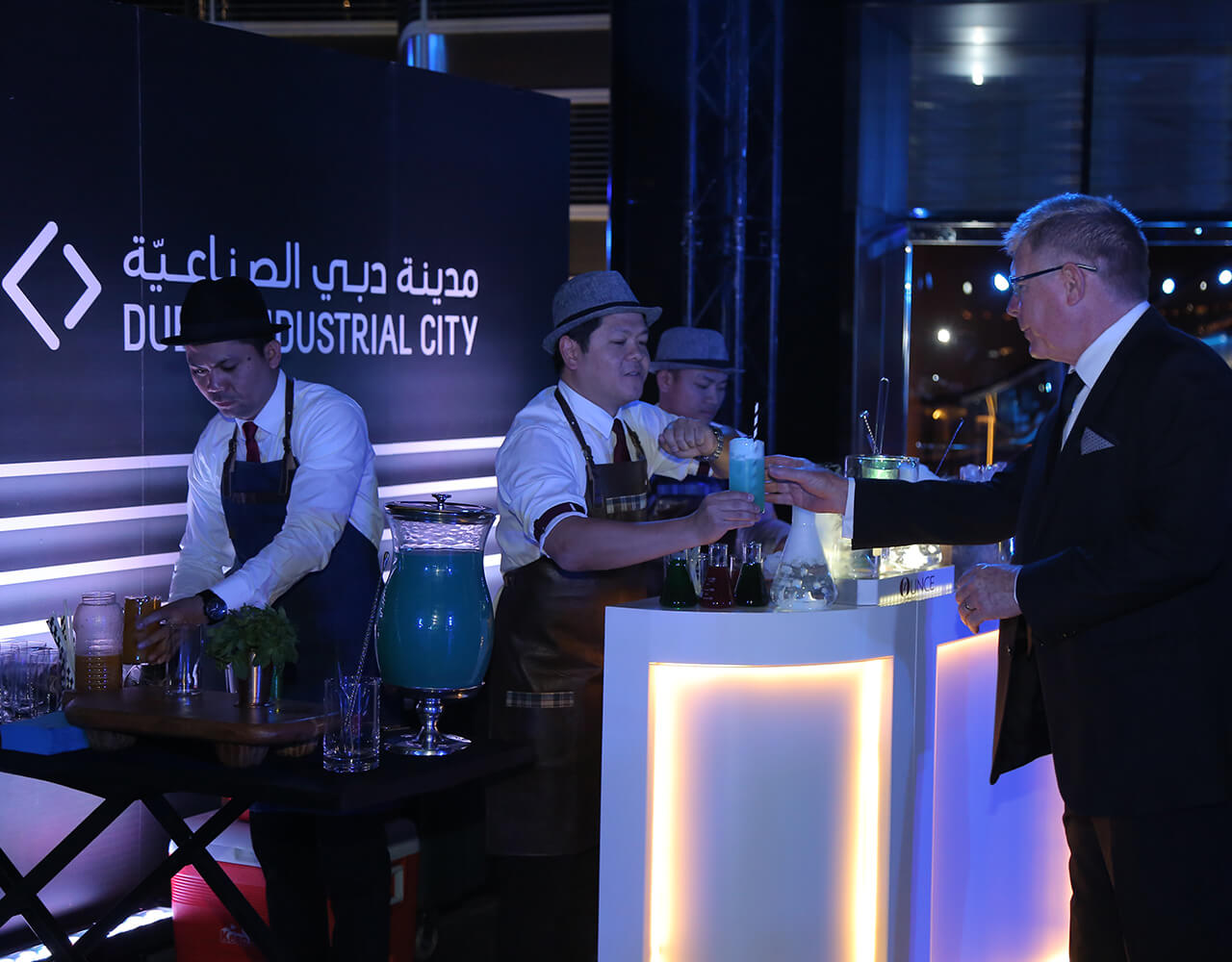 A man getting his drink from the drinks counter at Dubai Industrial City's Gala Dinner